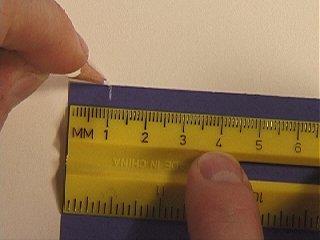 Measure one centimeter from the left corner of
