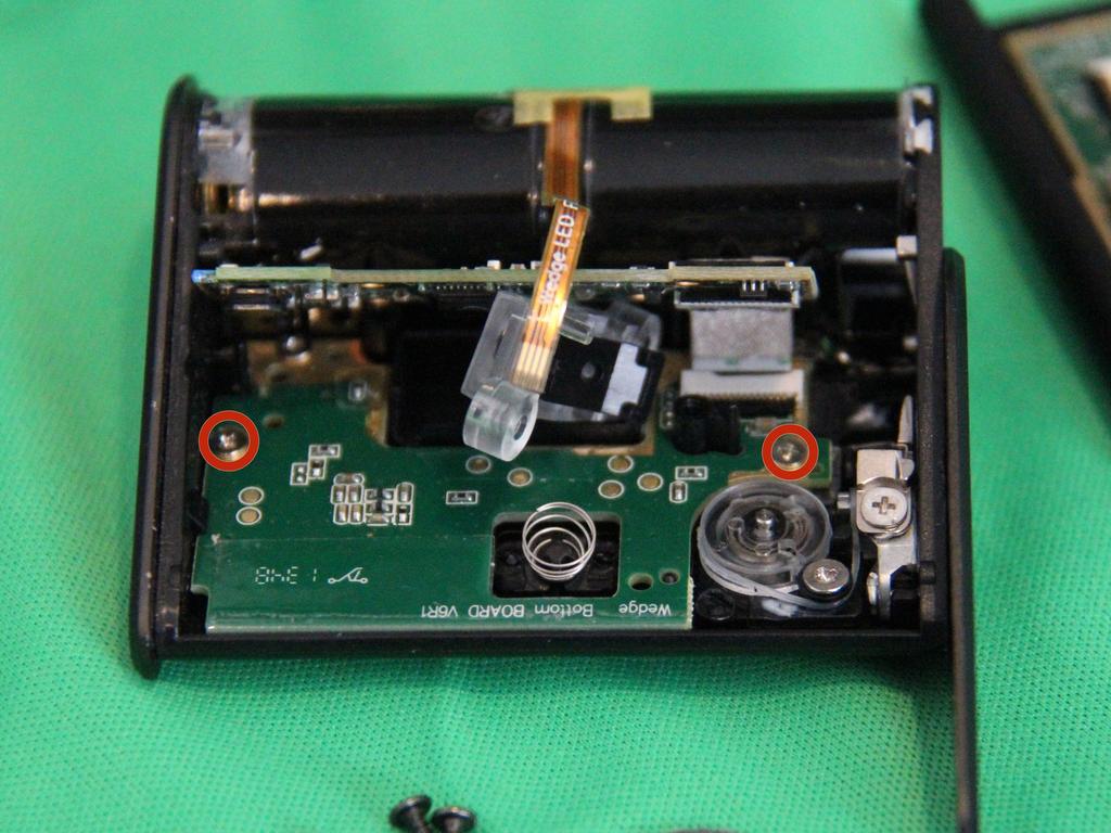 Repairing Microsoft Wedge Touch Mouse Battery Cover Retaining Clip Step 4 Rotate the upper board a little to expose the screws circled
