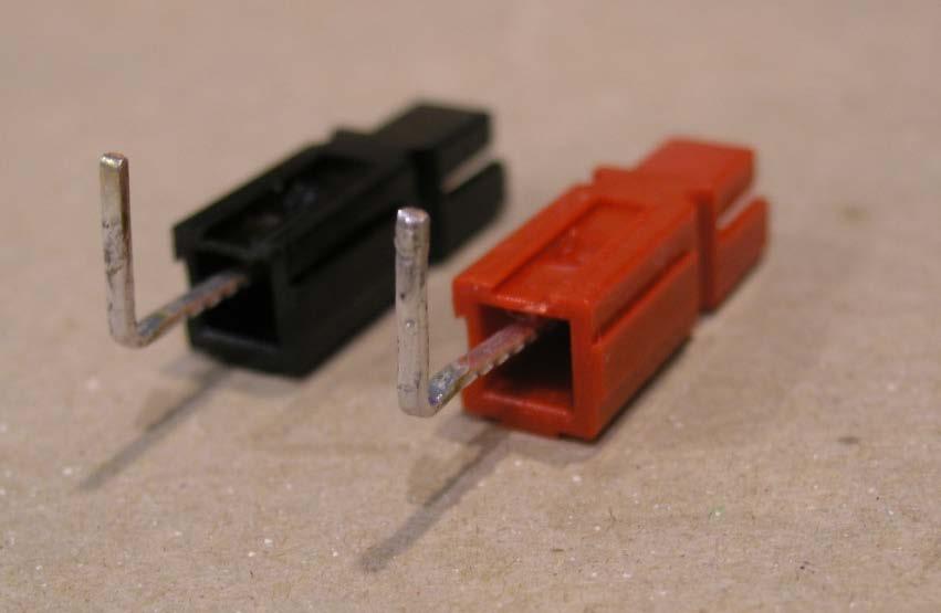 Figure 23. Rear side of DC power connectors with pins in place 10. The DC power connector bodies have rails and grooves on their sides that allow them to be joined together.