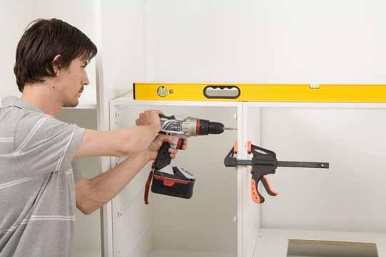 Once your first cabinet is in position, use a spirit level to check it is level, and adjust the feet accordingly.