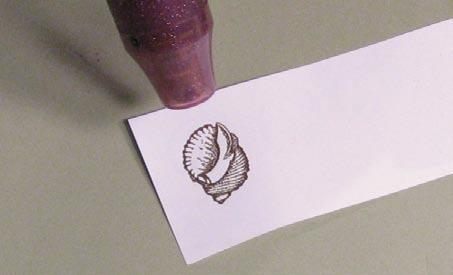 Shade and color the embossed shells. Judi used Aquacolor Crayons to create a soft colorwash on her shells.