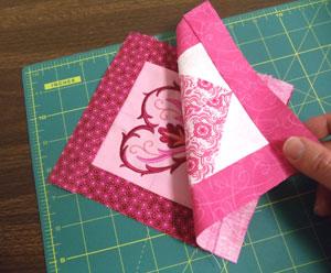 Now, add a border to each block just as you did for the embroidered blocks: for each block, cut two pieces of print cotton 1 1/2 wide by 5 inches high (for the sides) and two pieces 6 inches wide by