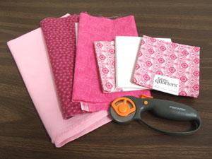 Supplies Needed: **1/2 yard solid-colored quilter's cotton (for borders and back) **1/4 yard solid-colored quilter's cotton (for embroidered blocks) **Small pieces of print quilters' cotton (for