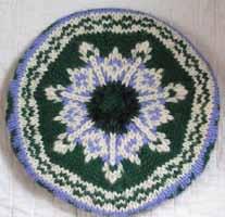While knitting a small sampler sweater from the neck down, traditional pattern motifs will be worked, including bobbles, traveling stitches, knit/purl motifs, baby cables, background stitches, and