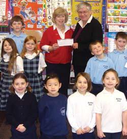 Community Commitment Kathleen Darcy, Vice President of Small Business & Community Development, presents a donation to St. Agnes Elementary School.