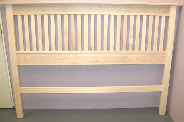 Place wooden dowels in the lower holes on both the middle headboard panel and bottom headboard brace.