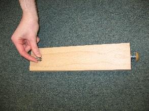 Put one dowel into each of the pre-drilled holes located on the inside edges of the rails. Tap into place.