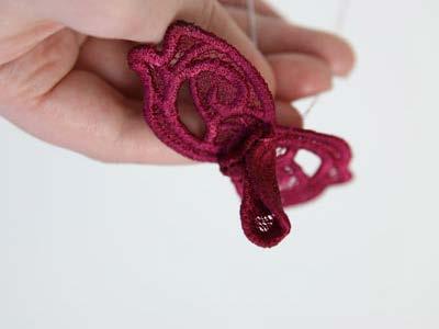 This is the center of the lace rose. String the embroidered lace piece "c" (the piece with two petals) onto the wire.