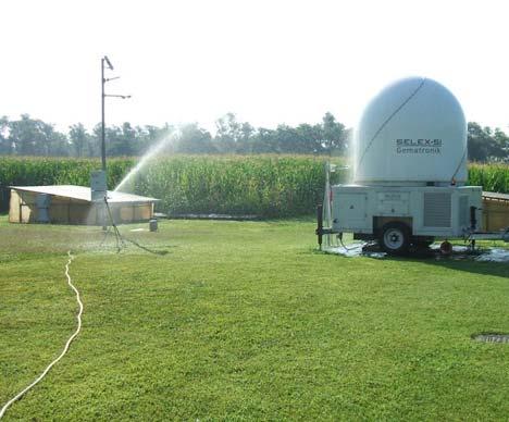 Figure 3. Left: the X-band radome irrigated with water. Right: time series of the gain during the metal sphere calibration. The drop in the power gain corresponds to the wet radome period.