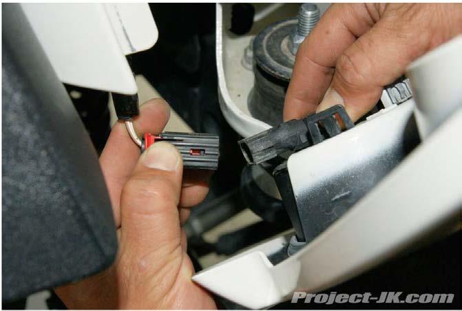 26. SQUEEZE THE WIRING HARNESS PLUG AND PULL IT OUT OF