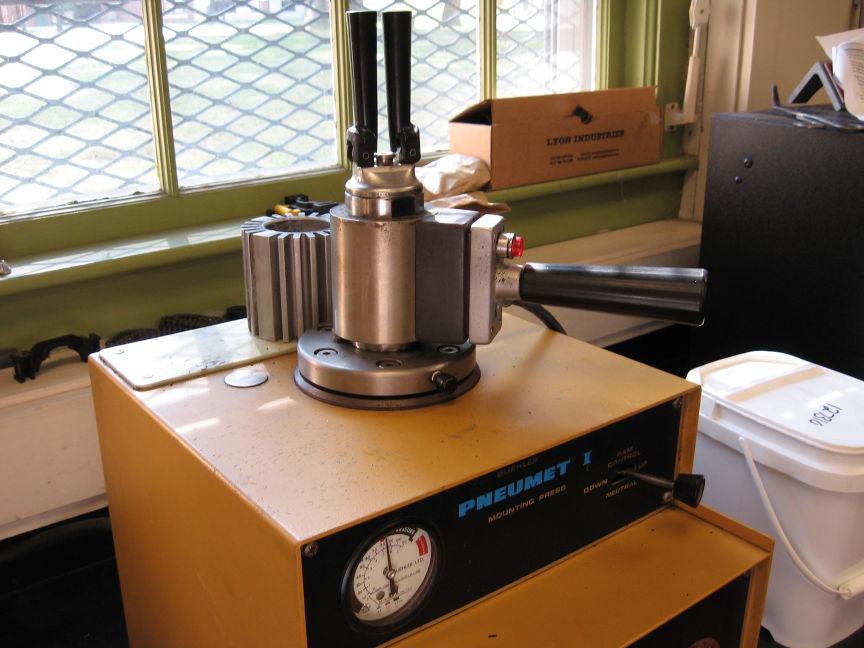 Place the Automatic Heater over the cylinder and turn it on. Figure 7 Pouring Phenolic powder into cylinder b. Set the timer to 7 minutes. c. It is a good idea to degas the sample.
