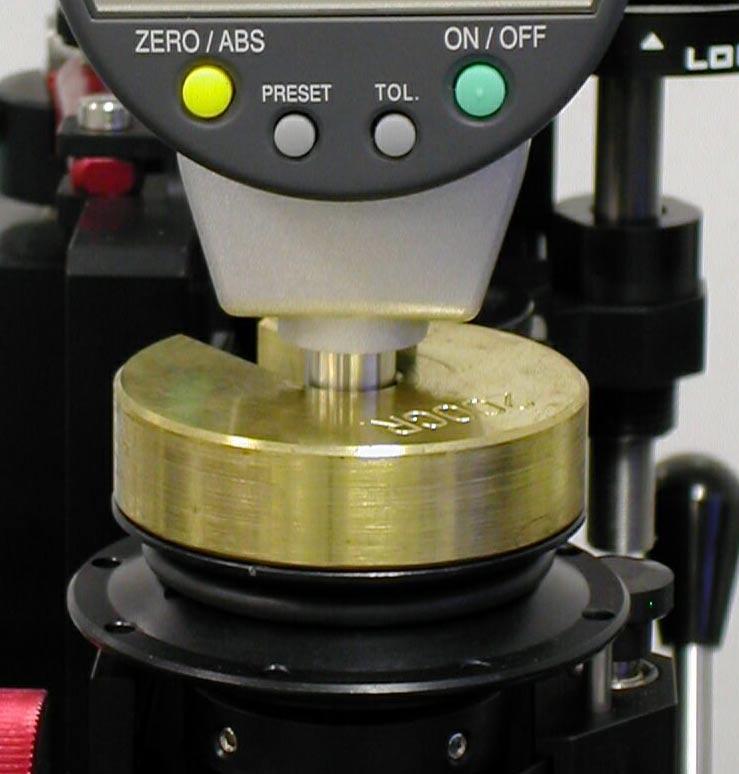 21. Stop the machine and lift the sample using the spindle riser. The spindle riser allows the mechanical stop position to remain intact and be used when the sample is placed back into position.