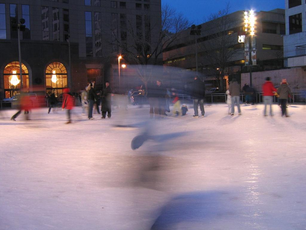 Can you tell me what the blurry thing in the foreground is? You can guess, but are you sure? It s quite difficult to convey, right? It could be a skater passing or twirling. Is it a kid? An adult?