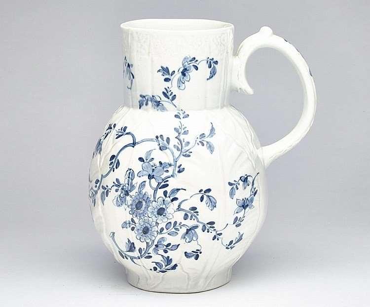 A First Period Worcester Porcelain Underglaze Blue Cabbage Leaf Floral Jug, Circa 1755-60. Dimensions: Height 8 1/4 inches x 7 1/2 inches wide x 6 inches.