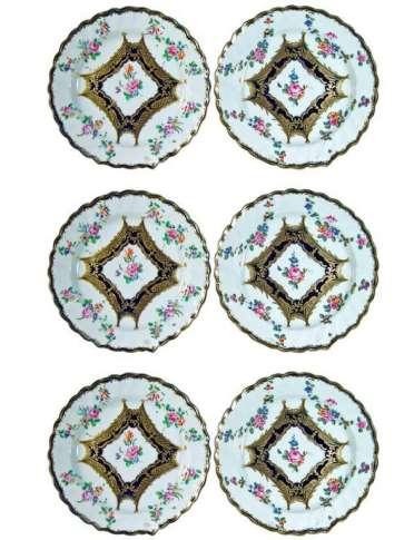 A Set of Six Chelsea Derby Porcelain Dessert Plates, Circa 1765. The plates are painted with a thin, spirally fluted, mazarine border accented with gilt highlights from which hang floral swags.
