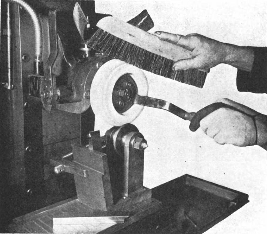 GRINDING-WHEEL FORM-CRUSHING 213 Figure 17.1 View of surface grinder, showing grinding wheel being turned by hand against the roller.