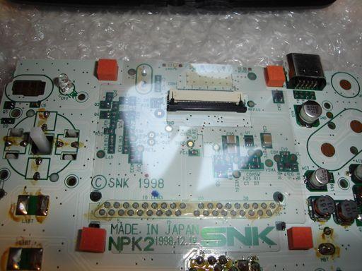 You will now see the front of the PCB which is white. Remove the 4 orange sponges from the board.