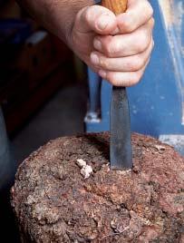 To mount a blank with an uneven surface between centers, chisel a V-groove