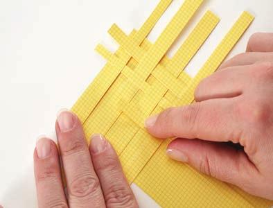 machine Paper punch Glue or foam squares Paper Weave Cut thin strips of