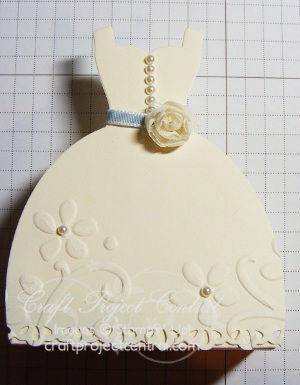 Adhere one of the dresses to the front of the purse, ensuring the