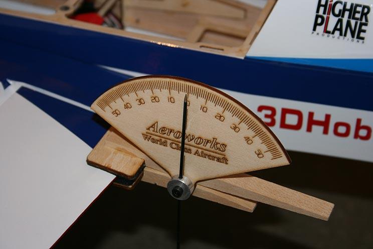 Neural aileron with the surface centered and the tail propped up to show zero degrees of throw on the throw meter 30 degrees of throw up aileron.