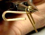 Using the middle part of your round nose pliers, make a loop about 3/4 inch from the tip of the wire to create a hook.