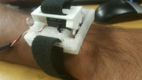 Velcro strap is wrapped around the wrist and connects to the attachment that turns. When the servo motor turns, the Velcro strap squeezes the user s wrist. Figure 1.
