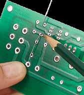 6. Insert one capacitor into each position and bend the legs out on the back side of the board (Figure 4).