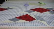 Sew one gray/beige section to the half drop diamond (end piece). matching the corners you marked earlier.