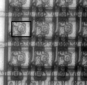 A microscope image of some pixels on the original 512x512 SLM is shown in Figure 4. The faint white rectangles are the reflective pixel pads (one is highlighted by a black rectangle).
