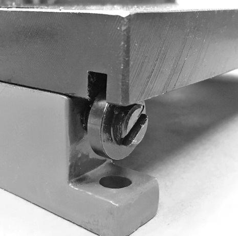 The hold-down bar (pressing plate) will press down on the material and hold it flat against the table surface to reduce curling. Then the shear will cut the material.