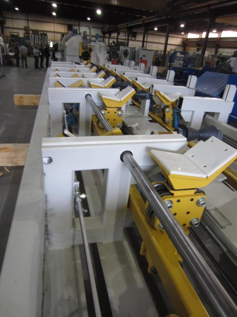 For example, in many large bar finishing cells, weighing, bar-end deburring, chamfering, stamping, NDE testing, are processes that are added in-line, each requiring special handling table features