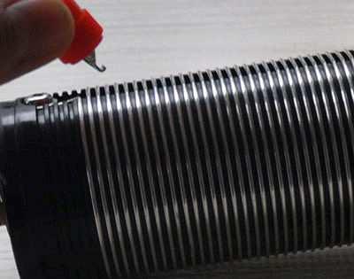 2. Small coil screw clip is used to hook one of the turns of wire on the coil.