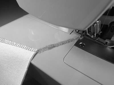 5 cm) down from the top of the fabric, and along the seam line. * Lift the presser foot and raise the needles.