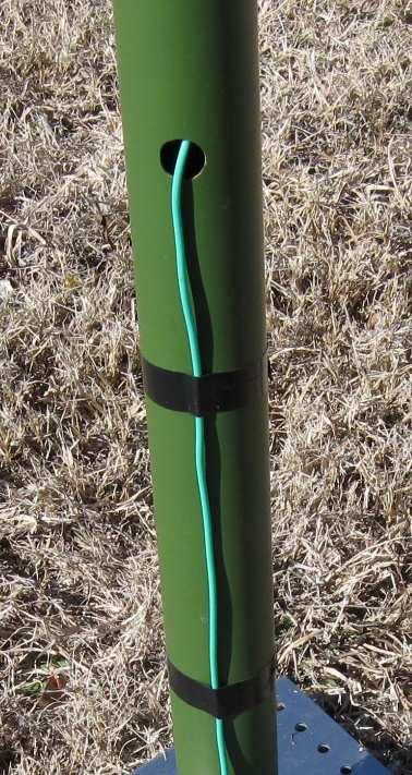 b. Use electrical tape to secure the vertical element wire below the base tube exit hole. If there is any slack in the vertical element wire, it should to be left ABOVE the electrical tape.