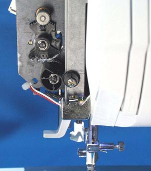 . Remove the presser foot nd the light over. 4. Loosen the enter srew (). 5. Turn the djusting srew () left or right until the needle flls enter position into the hole.