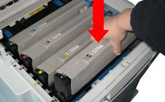 Holding the image drum and toner cartridge assembly by its top centre, lower it