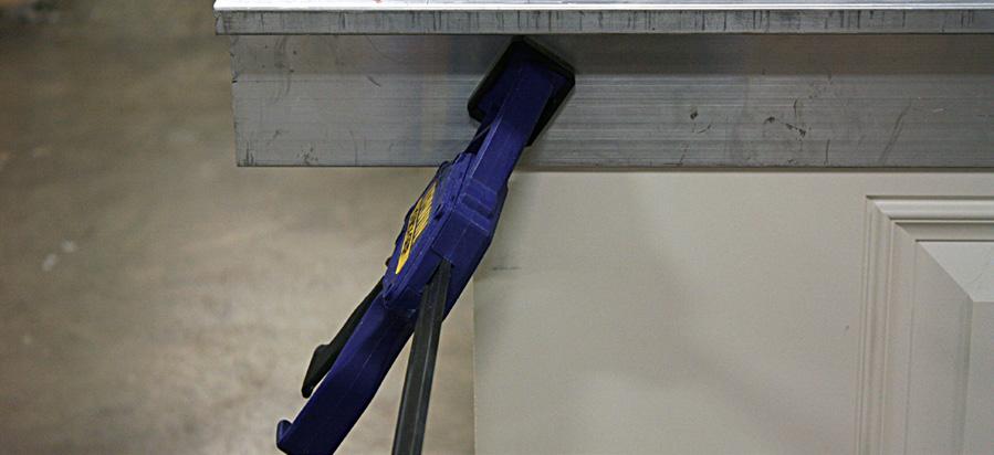 Tighten rails against door by securing twist bolts. F.