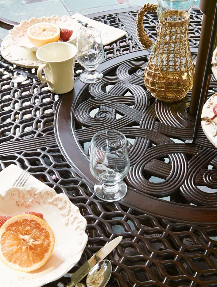 Graceful scroll patterns merge with the quatrefoil design to create an elegant surface on the dining table top.