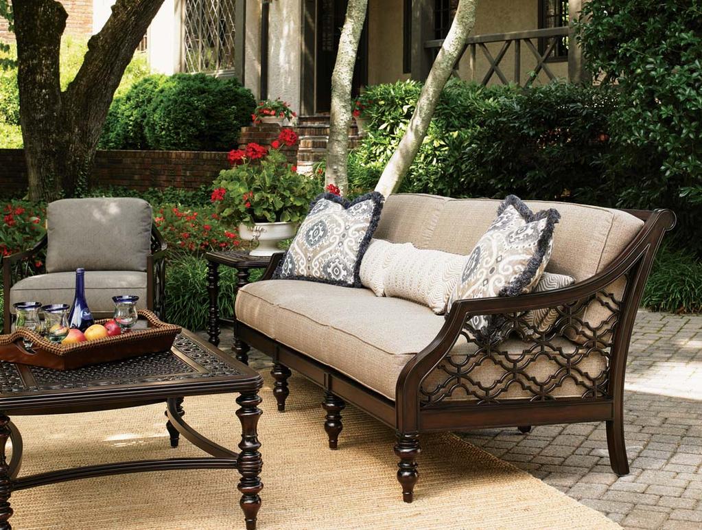The traditional quatrefoil design, executed in cast aluminum, features amazing detail, showcased against fabrics on the back and outside arms of the sofa and