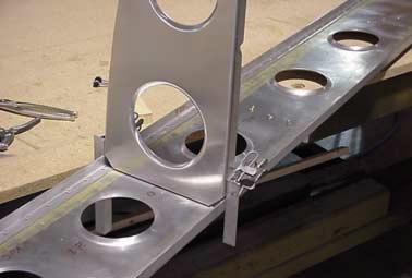 A small piece of material clamped to the flat edge will help in aligning the rib flange on the