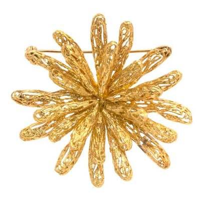 Sale 394 Lot 227 An 18 Karat Yellow Gold Brooch, Tiffany & Co., in an abstract burst design composed of textured gold openwork sections, the brooch measuring approximately 60.00 x 58.00 mm.
