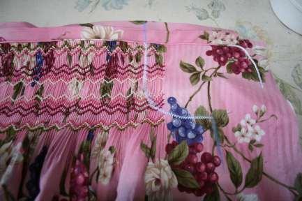 Stitch in place -Using binding, press under ¼ on both long sides of binding -Line up fold of binding with top row of smocking (or piping, if piping was used) open up