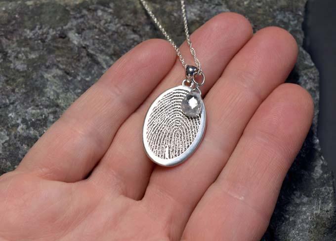 3507 Rim fi ngerprint oval non-ash holding pendant with April birthstone.