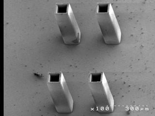 SEM pictures of the 351μm height microstructure made from photoresist 165 with 600 mj/cm 2 in i-line dominated UV broadband (A) feature size 4μm (B) feature size 9μm.