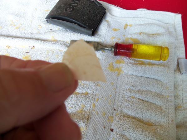 While most of the original finish will likely come off in smaller pieces, as can be seen on the towel in the background, some pieces may come loose as a larger area, I used a feeler gauge thick