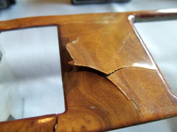 The tool needs to be thin to be able to be inserted behind the metal backing, flat so the tool does not leave marks pressed into the leather surround, and strong enough to pry the metal backing out