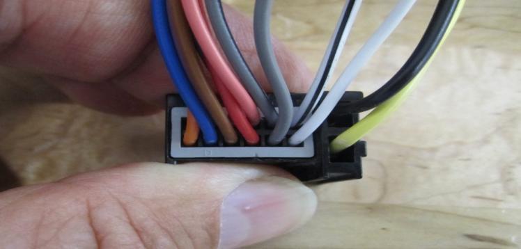 The wire in the pin 8 location has to be spliced into the wire in pin location 2 of the black connector #1 (see picture below).