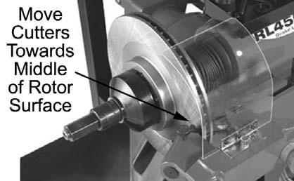 With the power turned off, install a silencer band that is appropriate for the rotor being machined. Stretch the band around the rotor and hook the metal loop over a lead weight. 6.