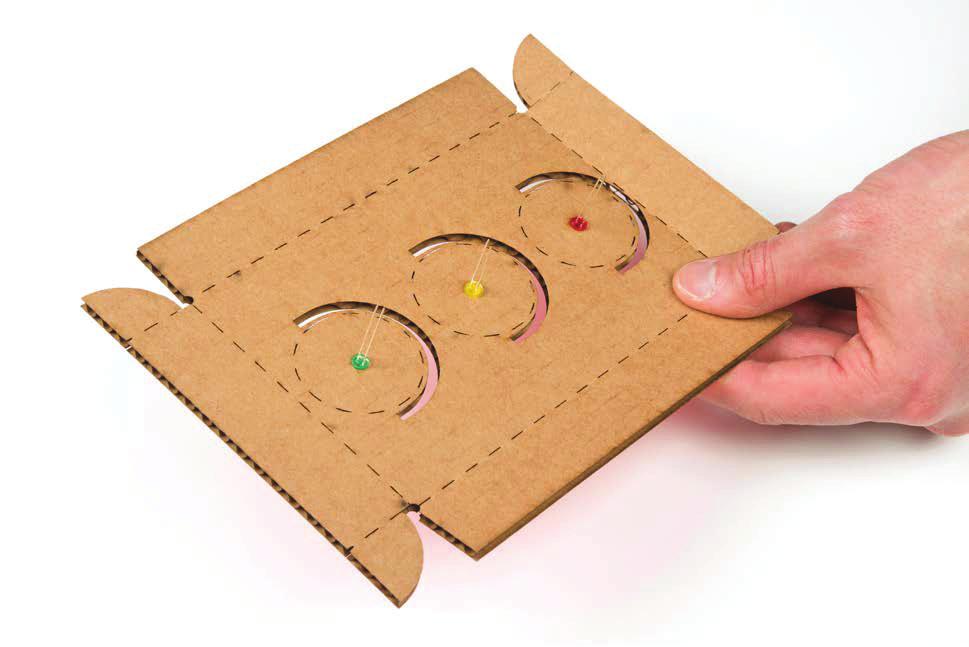 FIGURE 2-18: All three LEDs pressed into the cardboard Next, bend the cardboard along the scored lines, as shown in Figure 2-19.